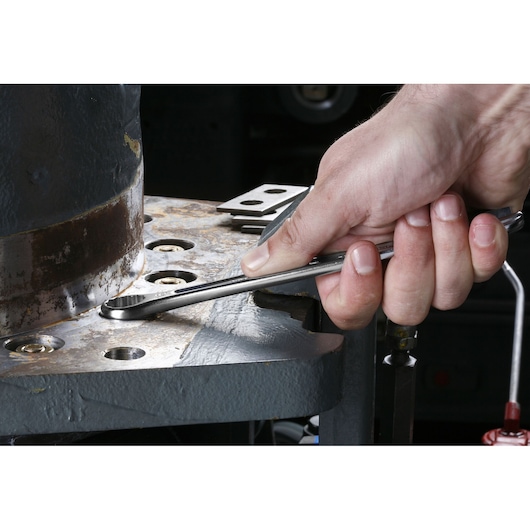 Photo of Facom combination spanner 440_11_16 being used to tighten a bolt on industrial machinery.
