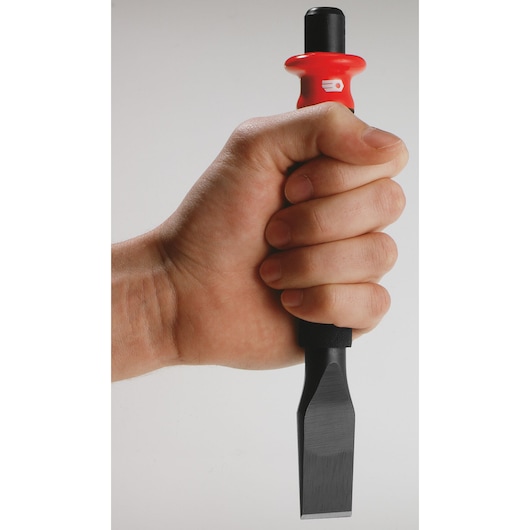 Photo of a hand holding a Facom chisel with a red and black handle, SKU 263_G20, close-up view.