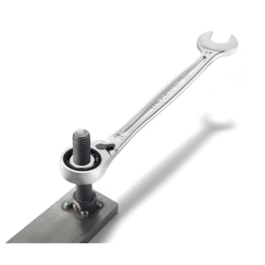 Facom 467B22 ratcheting combination wrench applied to a bolt, side angle on white background.