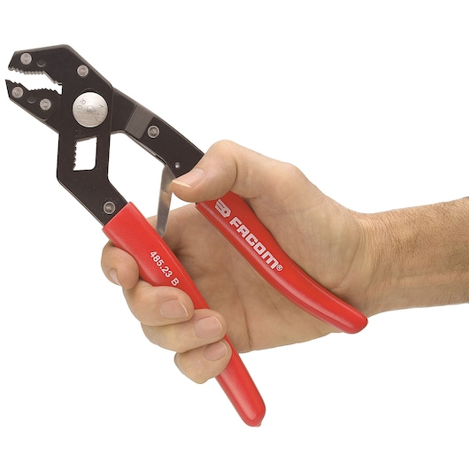 Photo of Facom 48517 adjustable pliers with red handles held in a hand, white background, tool category.