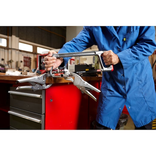 Facom 501AMP hacksaw used on metal clamped to workbench, workshop setting, product action.