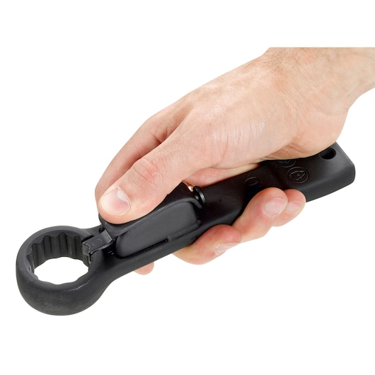 Photo of Facom 51BS27 black ratcheting socket wrench in hand, close-up on white background.