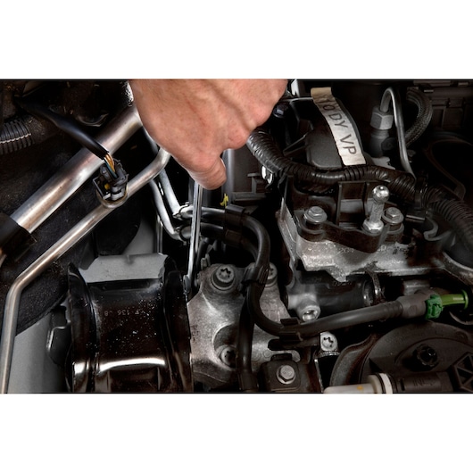 Facom 59_30X32 wrench used on engine component, detail view of automotive repair.