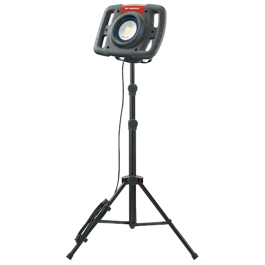 Facom 777_SPOTBT portable LED work light on tripod stand, front angle, black housing and red label.