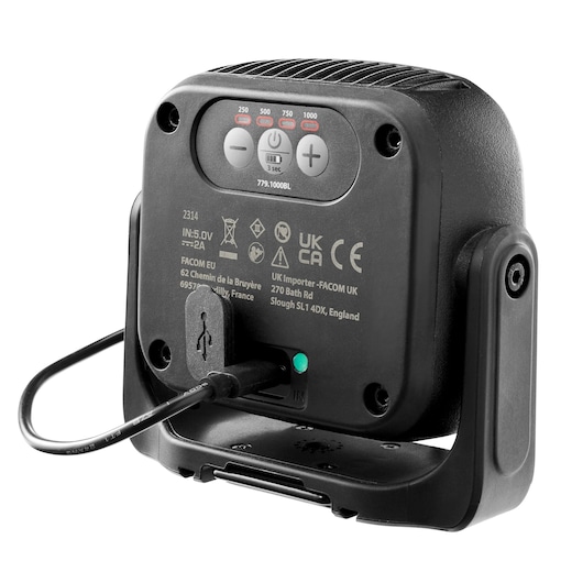 Facom 779.1000BLPB work light rear view showing charging cable connected, control buttons, and certification markings.