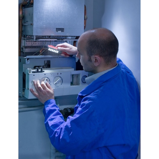 Facom 779.PENPB photography of technician inspecting boiler with LED work light.