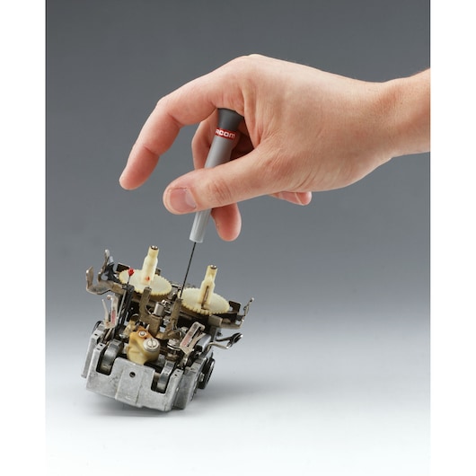 Facom 84E_1_3X35 precision screwdriver used for electronic component assembly, hand shown holding tool.