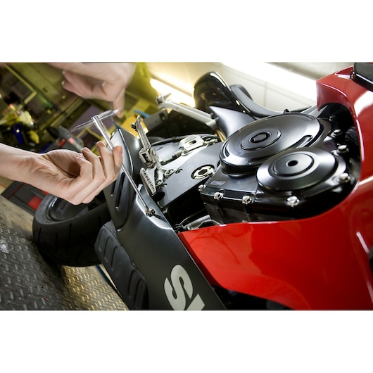 Facom 84TCD_8 T-handle hex key being used to adjust a motorcycle engine close-up.