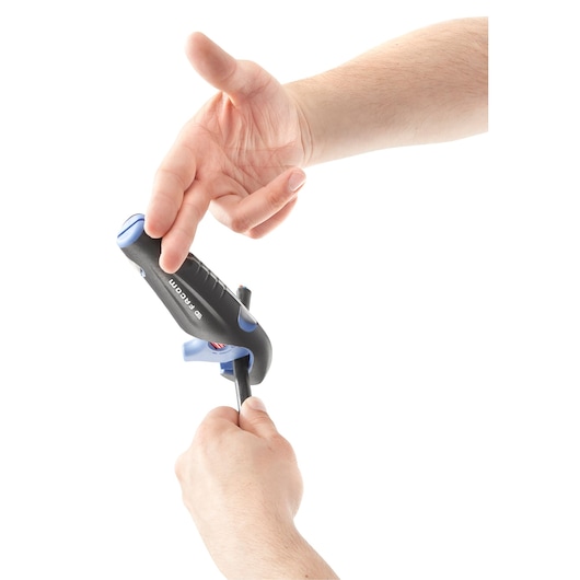 A close-up view of hands using a Facom tool with a black handle and blue accents to strip the covering off a black electrical wire.