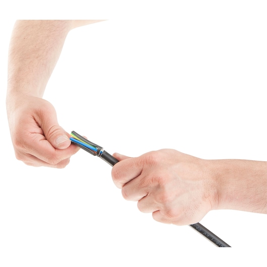 Two hands are shown stripping the outer sheath from a multicolored electrical cable, revealing multiple wires inside.