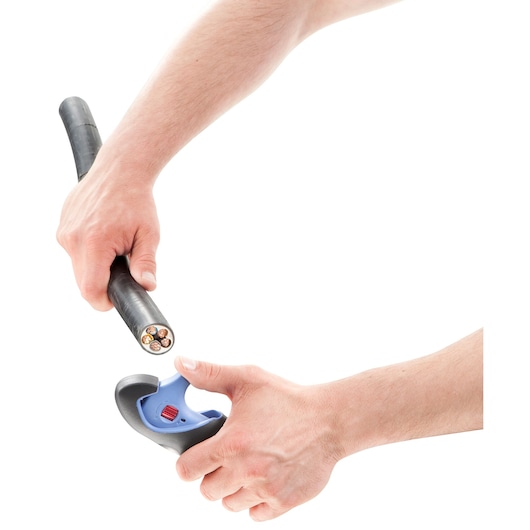 Photo of Facom 872271 cable stripping tool in use cutting thick black electrical cable, white background.