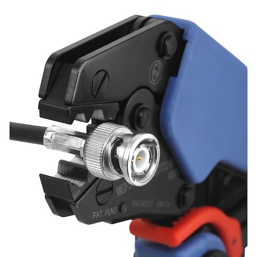 Facom 985758 crimping tool close-up on white background, securing BNC connector to coaxial cable.