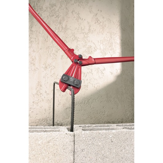 Facom 990_B2 bolt cutter cutting rebar over concrete blocks, photography product category.