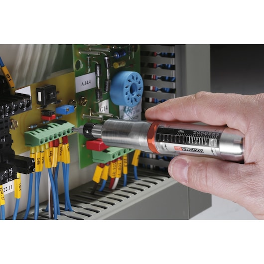 Facom A_301MT torque screwdriver used to fasten a screw on an electronic circuit board with multiple colored wires.