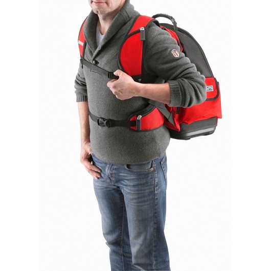 Photo of Facom BS.L30PB red and black backpack worn by a person, showing front and side strap details.