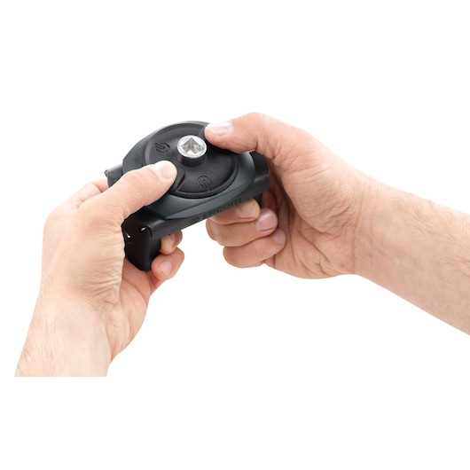 Photo of Facom C48-2 hand-operated tool being held, showing round black body with central metal component.