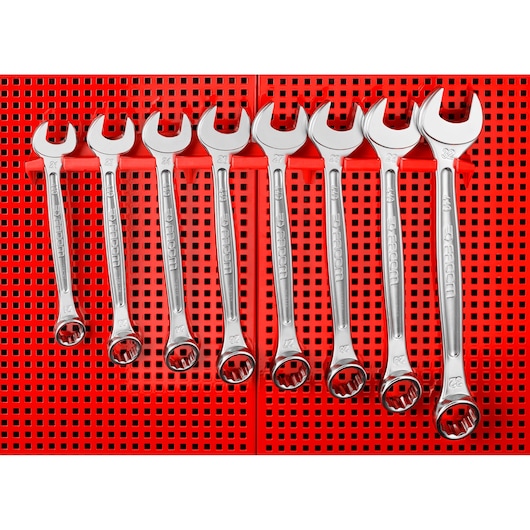 Photo of Facom CKS_101 combination wrenches set, seven chrome wrenches on red perforated background, front angle.