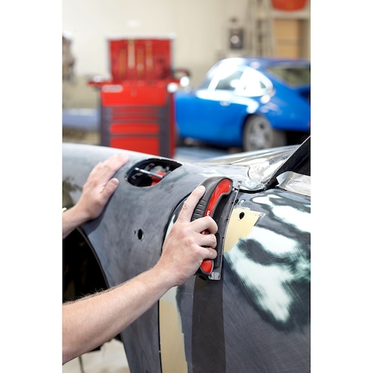 Facom CR_SBS sanding block used on car bodywork in workshop, close-up photography.