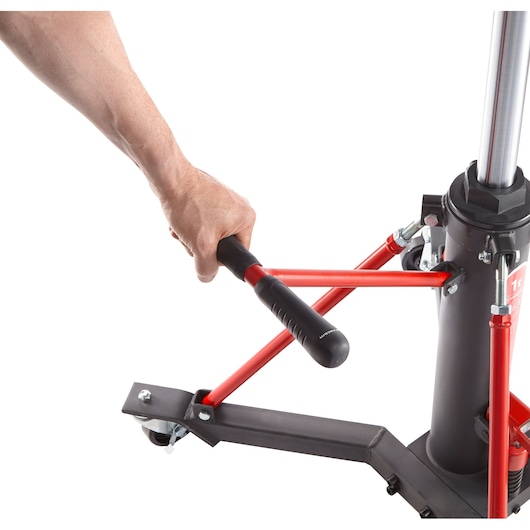 Facom DL1000 hydraulic jack with red handle and black base, side angle, hand operating handle.