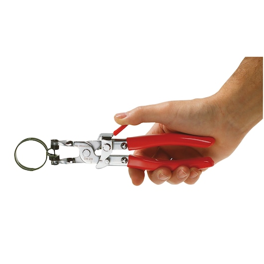 Photo of Facom DM_25 snap ring pliers with red handles in hand, shown from side angle.