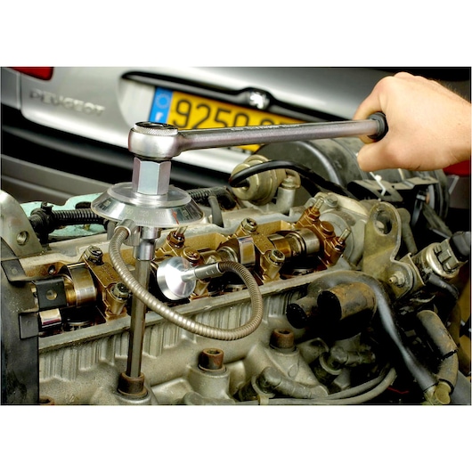 Facom DMP_360L torque angle gauge tool in use on engine for automotive repair photography.