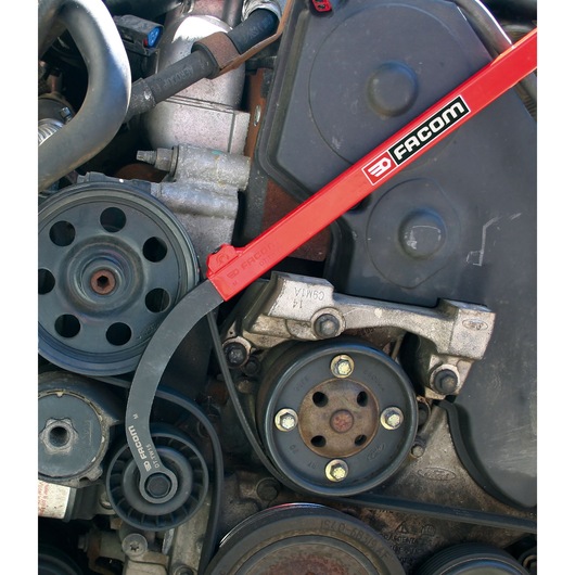 Facom DT_TW13 red and black automotive tool in use on engine pulleys, close-up photography.