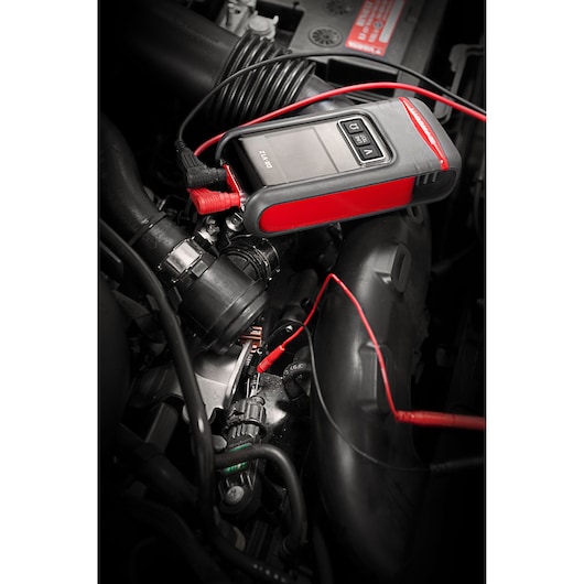 Facom DX_SET automotive diagnostic tool with red and black design connected in a car engine bay.