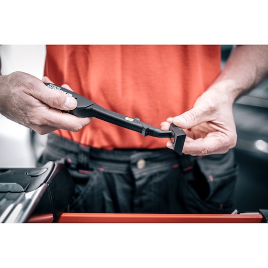 Photo of Facom DX_TSCANPB inspection tool held in hands, black handle and probe visible.