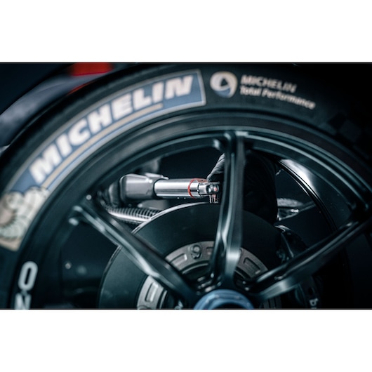 Facom E_516ST-340PB torque wrench on motorcycle wheel, close-up with Michelin tire.