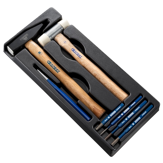 Facom E010506 tool set with hammer, mallet, and five blue-handled punches in black tray, top view.