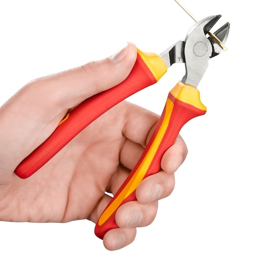 A hand holding a pair of red and yellow insulated diagonal cutting pliers, cutting a thin wire.