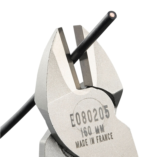 Facom diagonal cutting pliers E080206 close-up on white background, cutting a black wire.