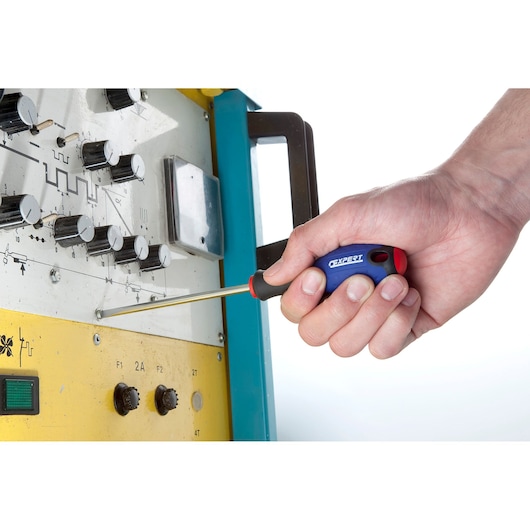 Facom E165093 screwdriver with blue handle used to adjust screws on an electronic control panel.
