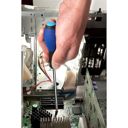 Facom E165335 screwdriver with blue handle used to tighten screw in computer motherboard.