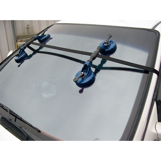 Facom E201501 windshield removal tool with three blue suction cups mounted on a car windshield.