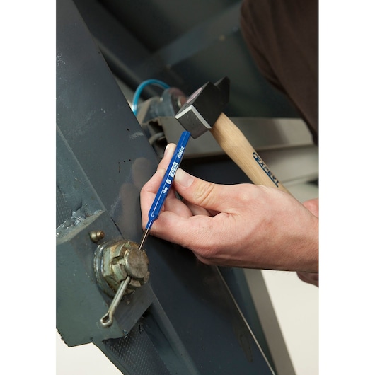 Facom E418233 punch tool in use with hammer on metal machinery.
