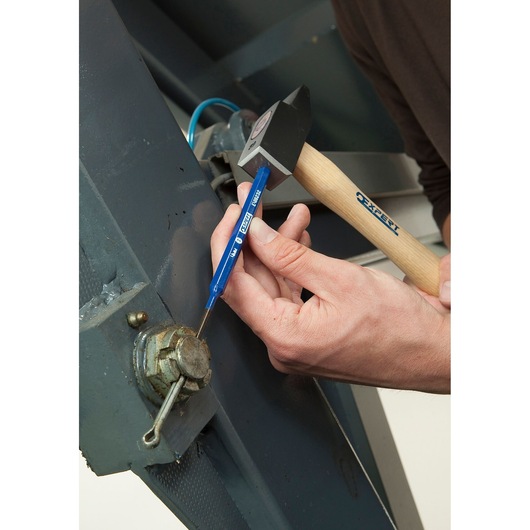 Facom E418233 blue punch tool in use, striking metal with hammer during mechanical maintenance.