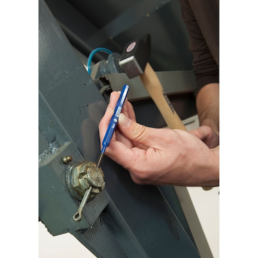 Facom E418234 blue steel punch tool used on metal machinery, held by hand.