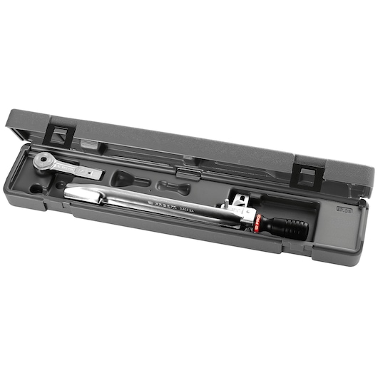 A Facom torque wrench set in a grey plastic case, showing the wrench and its accessories neatly organized inside.