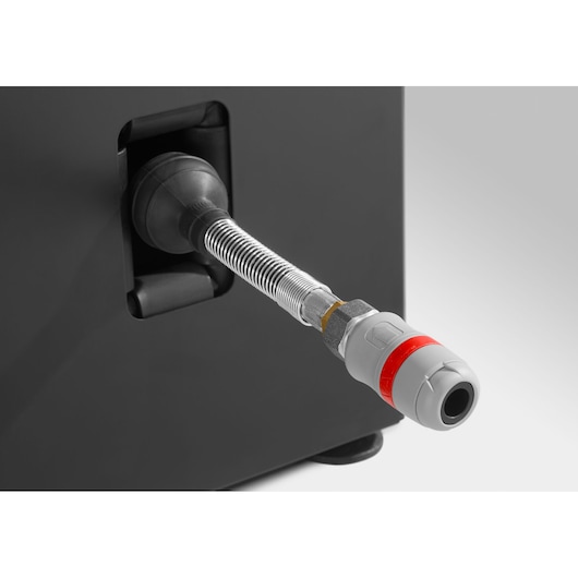 Facom JLS3-PSHPOWER close-up of flexible metal air hose connector with grey and red coupling on black equipment.