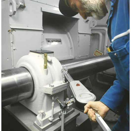 Facom K_201B torque wrench used by technician on industrial machinery, close-up photography.