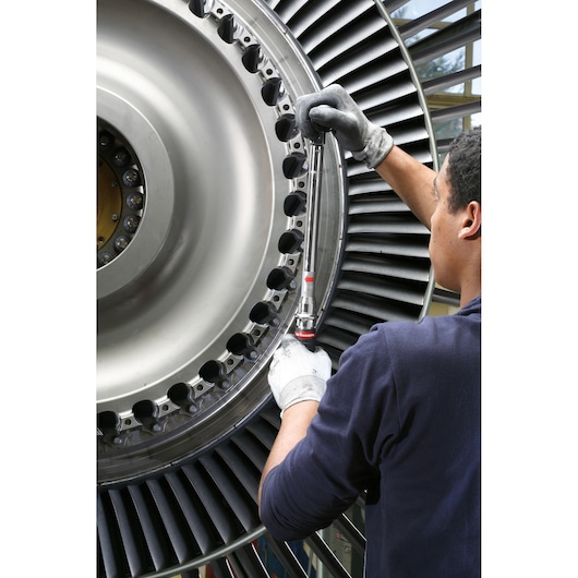Facom R306A25 ratchet wrench used on large turbine, engineering photography.