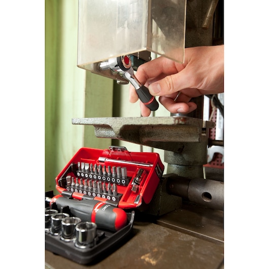Facom R.360NANOPB ratchet bit set used on machinery, photo shows red tool case and assorted bits.