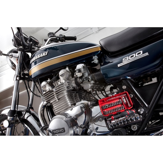 Facom RL.NANO1PB red socket and bit set photography on motorcycle engine close-up.