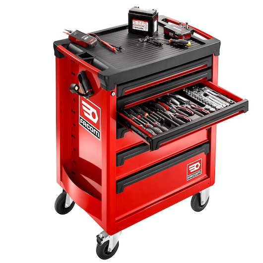 Facom ROLL.6M3APB red tool trolley with open drawer, assorted hand tools, and top electrical testing accessories, angled view.