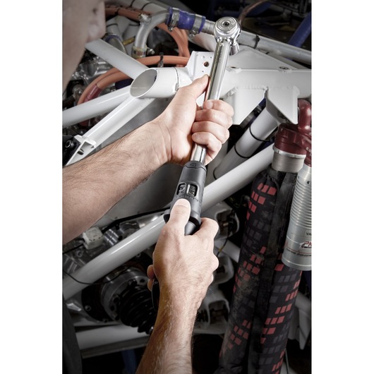 Facom S_209-100PB torque wrench in use adjusting bolts on machinery.