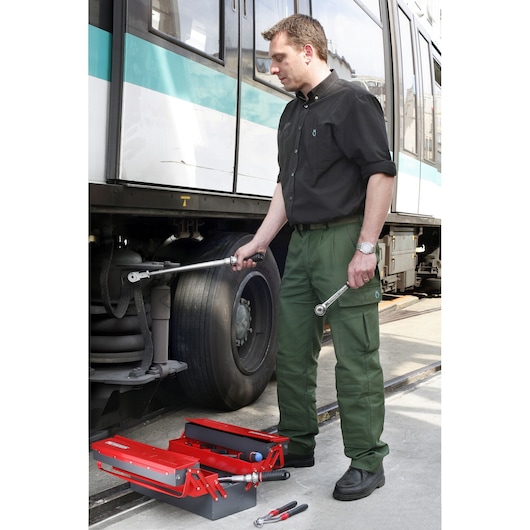 Facom S_306-100R red tool box with hand tools near train wheel, front angle, SKU S_306-100R.