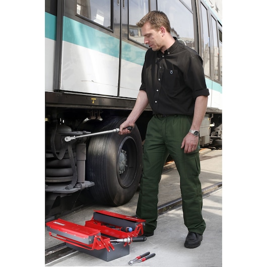 Facom S_306-200R red tool box with tools near train wheel, outdoor angle, SKU S_306-200R