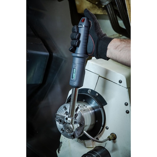Facom S.307-100D digital torque wrench in use on industrial machinery, close-up photography.