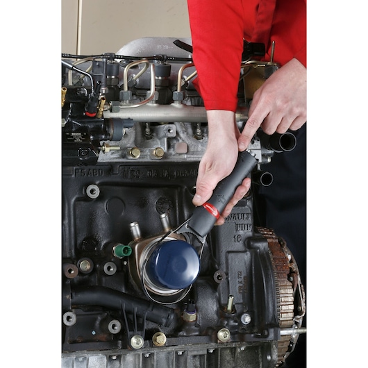 Facom U.48PB oil filter wrench in use on engine, close-up photography.